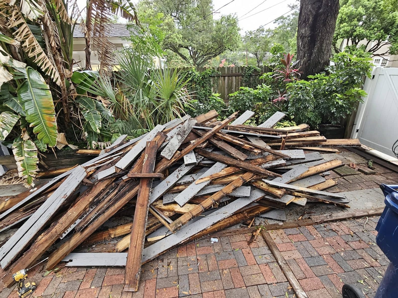 Old deck material removed and stacked for haul-off during demolition